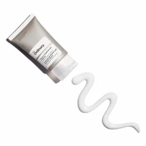 A product shot of The Ordinary Vitamin C Suspension 30% in Silicone tube next to a smooth, velvety white product swatch, showing the silicone-based texture.