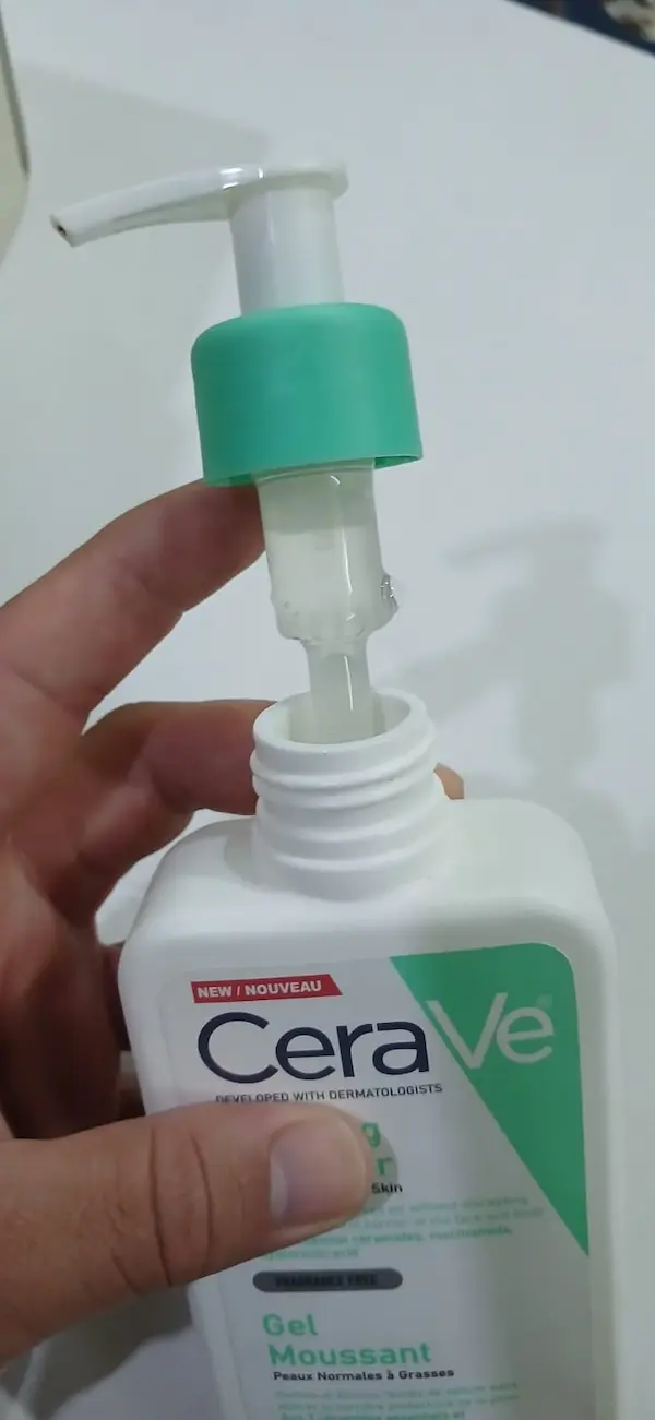 Fake CeraVe cleanser pump pulled out, showing no spring inside the bottle