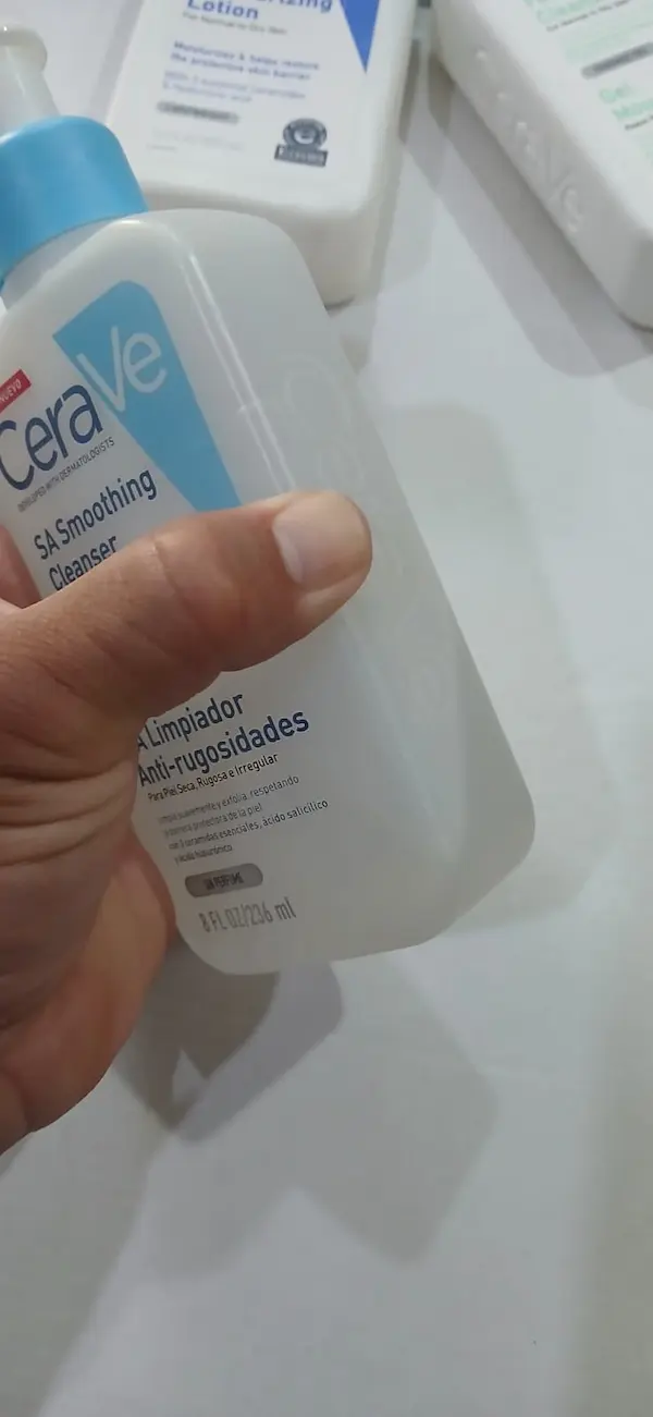 Fake CeraVe SA Smoothing Cleanser being pressed, the hard bottle does not press in