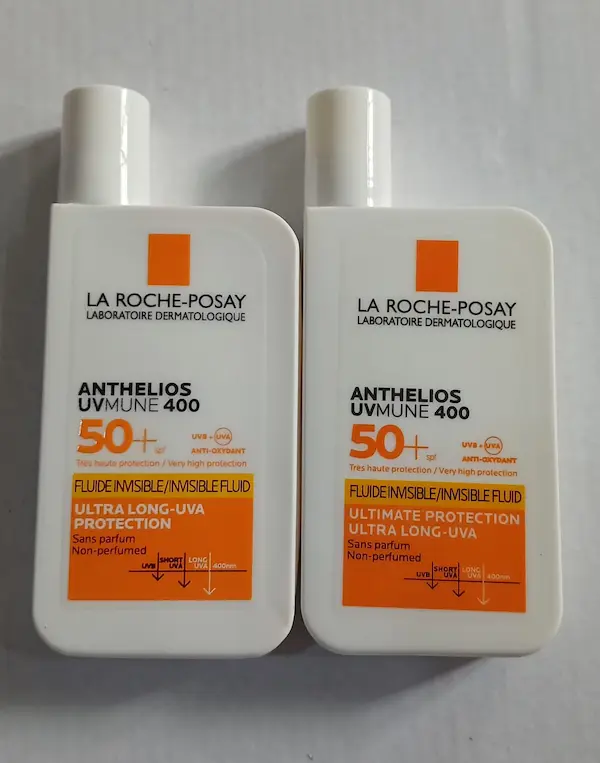 Original and fake La Roche-Posay Anthelios invisible fluid sunscreen bottles side by side, looking almost identical and hard to tell apart by eye