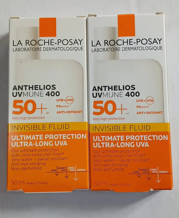 Original and fake La Roche-Posay Anthelios sunscreen boxes side by side, looking almost identical and hard to tell apart by eye